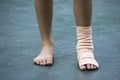 The gauze bandages around the Ankle boy and leg swelling from inflammation On a green background