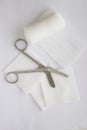 Gauzes, scissors and roll gauze on white background,top view,closed up