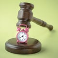 Gavel and clock on green