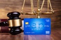 Gavel And Blue Credit Card On Wooden Table