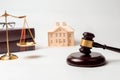 Gavel, books, scales of justice with house model for lawyer courtroom decoration object.