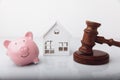 Gavel, broken piggy bank and house model isolated on white. Auction concept Royalty Free Stock Photo