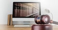 Gavel and computer with books of law and justice Royalty Free Stock Photo