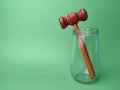 Gavel and glasses jar on a green background Royalty Free Stock Photo