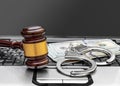 Gavel, handcuffs and money on the laptop keyboard. Close up Royalty Free Stock Photo