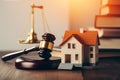 Gavel, house and books on wooden table. Law and justice concept Ai generative Royalty Free Stock Photo