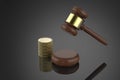 Gavel judge with stack of coins