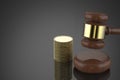 Gavel judge with stack of coins