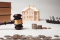 Gavel of lawyer with education book, house model and coin. Royalty Free Stock Photo