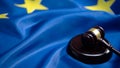 Gavel lying on sound block against European Union flag, court of justice Royalty Free Stock Photo