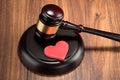 Gavel and red heart on table Royalty Free Stock Photo