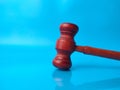 Gavel with reflections on a blue background with copy space. Royalty Free Stock Photo