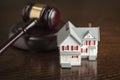 Gavel and Small Model House on Table