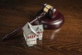 Gavel and Small Model House on Table