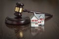 Gavel and Small Model House on Table