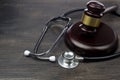 Gavel and stethoscope on black wooden background Royalty Free Stock Photo