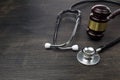 Gavel and stethoscope on black wooden background Royalty Free Stock Photo