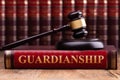 Gavel And Striking Block Over Guardianship Law Book Royalty Free Stock Photo