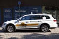 a white taxi waiting for customers to drive