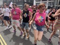 Gay activists dancing with LGBT flags at the Pride parade in London , England 2023