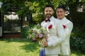 Lgbt gay bride and groom with flower bouquet in wedding ceremony Royalty Free Stock Photo