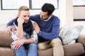 Gay couple comforting each other on the couch Royalty Free Stock Photo