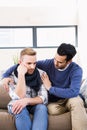 Gay couple comforting each other on the couch Royalty Free Stock Photo