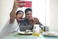 Gay Couple Eating Breakfast Taking Selfie With Phone Royalty Free Stock Photo