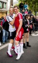 Gay couple in heels, dressed as football players.