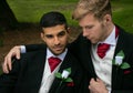 Gay weddings, grooms, couples pose for pictures after their wedding ceremony in churchyard Royalty Free Stock Photo