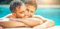 Gay couple relaxing in swimming pool. LGBT. Two young men enjoying nature outdoors, kissing and hugging Royalty Free Stock Photo