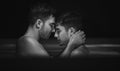 Gay couple relaxing in swimming pool. LGBT. Two young men kissing and hugging. Black and white portrait Royalty Free Stock Photo