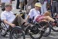 A gay couple riding the recumbent tricycle and holding hands attending the Gay Pride parade in Munich