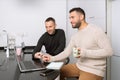 Gay couple working together at home with their laptops. Royalty Free Stock Photo