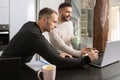 Gay couple working together at home with their laptops. Royalty Free Stock Photo