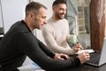 Gay couple working together at home with their laptops. Royalty Free Stock Photo