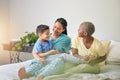 Gay family, morning and playing on bed in home bedroom for bonding, quality time and love. Adoption, lesbian or LGBTQ Royalty Free Stock Photo