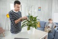 Gay jolly man loving his plant