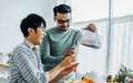 Gay LGBT sweet Asian couple wearing pajamas, smiling, with happiness and love while making and pouring juice smoothie to glass and Royalty Free Stock Photo