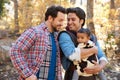 Gay Male Couple With Baby Walking Through Fall Woodland Royalty Free Stock Photo