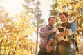 Gay Male Couple With Baby Walking Through Fall Woodland