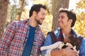 Gay Male Couple With Baby Walking Through Fall Woodland Royalty Free Stock Photo