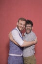 Gay men acting silly, hugging together