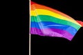 Gay Pride Flag, sunlit against the black sky Royalty Free Stock Photo