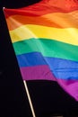 Gay Pride Flag, sunlit against the black sky Royalty Free Stock Photo