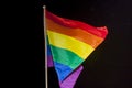 Gay Pride Flag, sunlit against the black sky Royalty Free Stock Photo