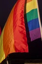 Gay Pride Flag, sunlit against the black sky Royalty Free Stock Photo