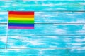 Gay pride flag on wooden table. Close up. Royalty Free Stock Photo