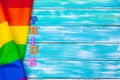 Gay pride flag on wooden table. creative photo. Royalty Free Stock Photo