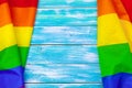 Gay pride flag on wooden table creative photo. Royalty Free Stock Photo